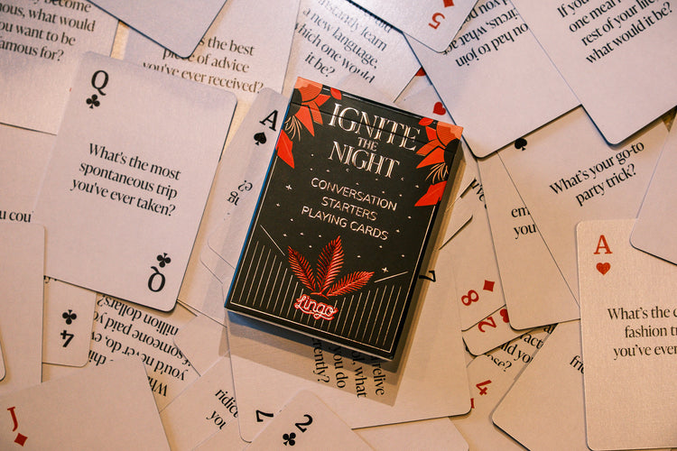 Ignite The Night Playing Cards – box resting on a spread of cards